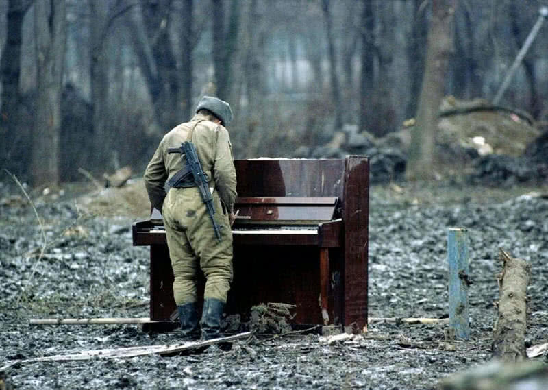 Russian Soldier playing abandoned piano in Chechnya